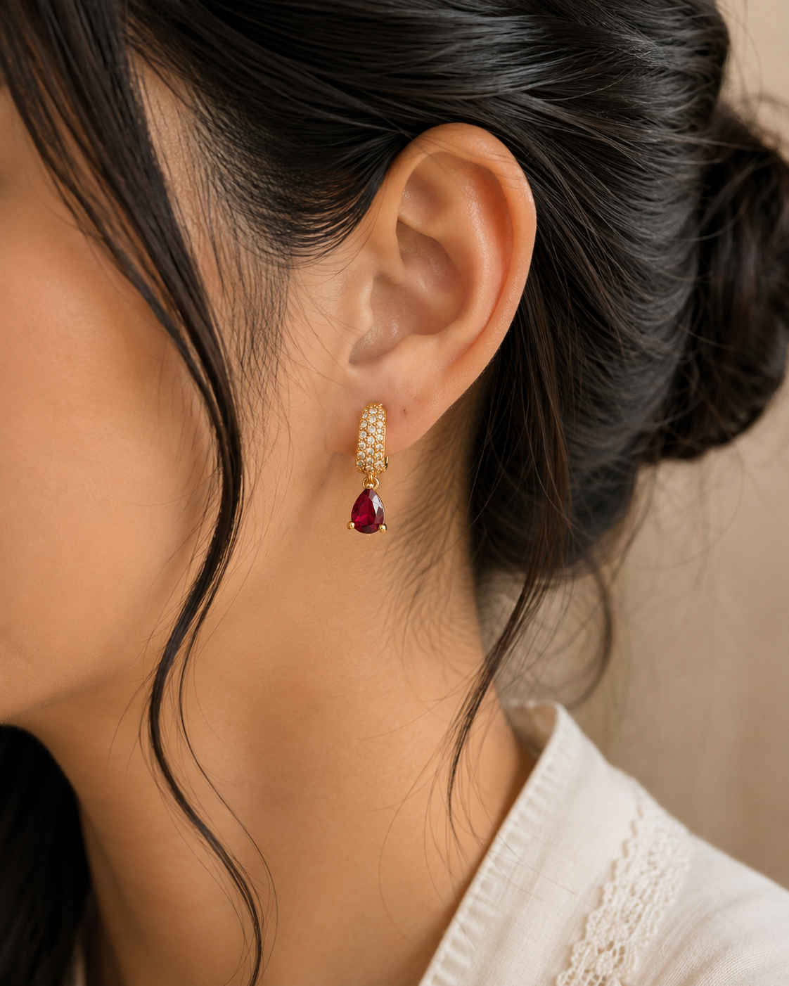 Ruby Teardrop Pavé Huggie Earrings worn on ear